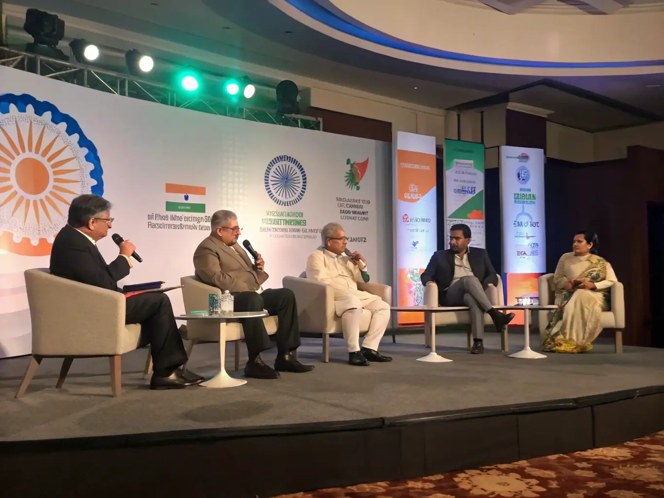 A visually appealing image showcasing a panel discussion with prominent Indian startup founders at a Startupsummit conference in Delhi, India.